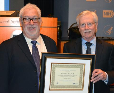 Dr. Sher holds plaque presented by Dr. Koob