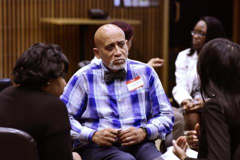 Tyson sits with two students during a mentoring session