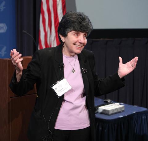 Dr. Catherine DeAngelis speaking and gesturing with her hands raised.