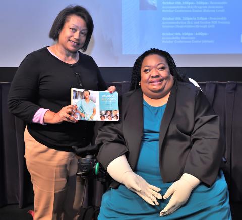 Crystal Emery (r) with EDI’s Kay Johnson Graham, holding Emery’s recent book.