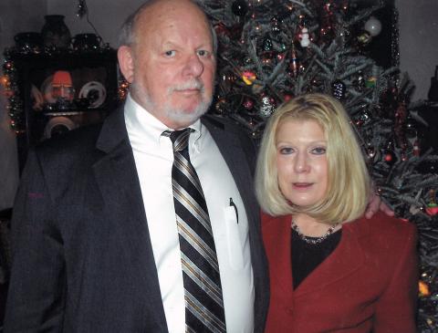 Dr. Guadagno and husband Dr. Micklin in front of their Christmas tree