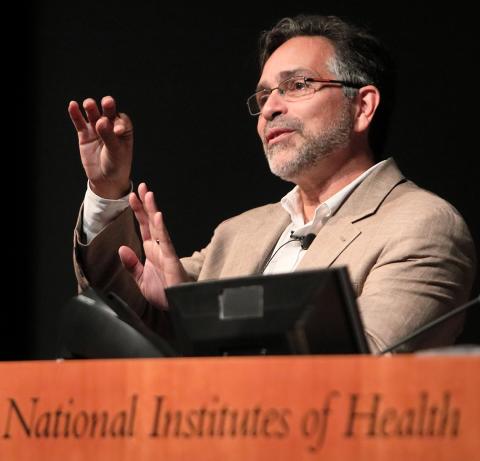 Dr. Alejandro Sánchez Alvarado motions with hands at the podium