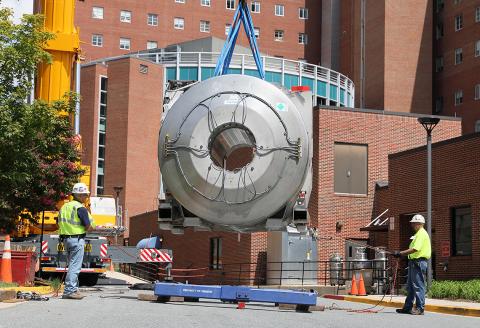 A crane lifts the magnet weighing 38,000 pounds.