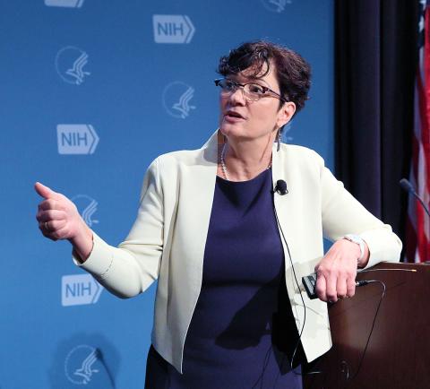 Dr. Mary Jo Larson speaking at the podium.