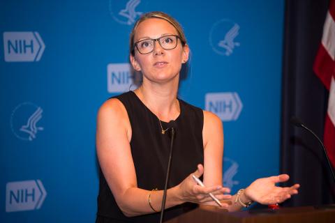 Sanderson speaking at the podium.