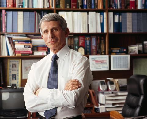 Fauci folding his arms in an office