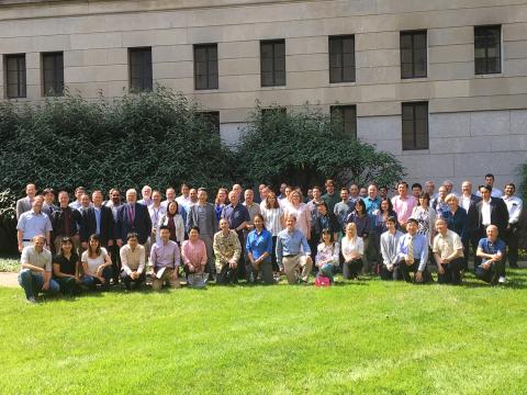 Large group poses outdoors with Dr. Mattson.