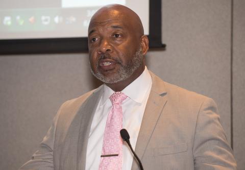 Danny Dickerson speaks at podium