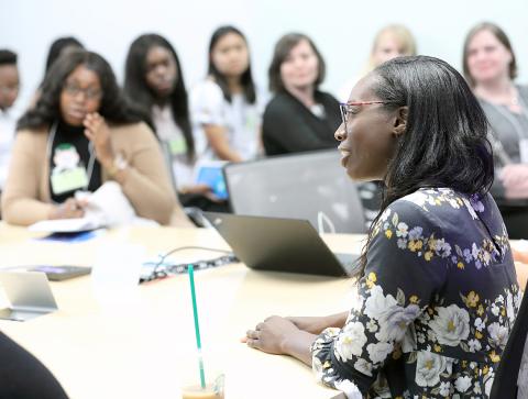 Williams chats with STEM students around table.