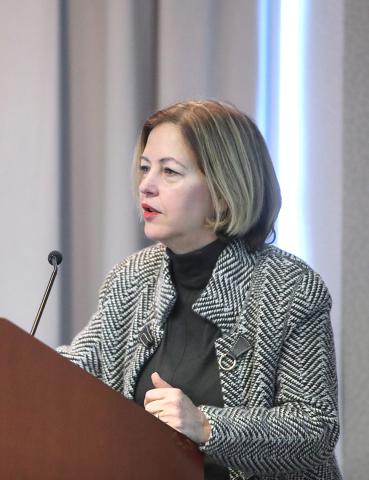 Dr. Alegría speaks at a podium