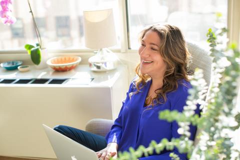Spero smiles as she looks up from her laptop