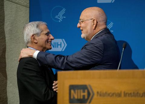 Greeting one another at the podium are Redfield and Dr. Fauci