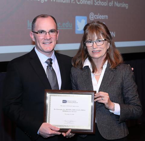 Dr. Lee holds plaque he received from NINR acting director Dr. Cashion, also pictured