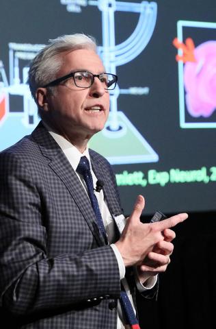 Kochanek speaks with slide projected behind him