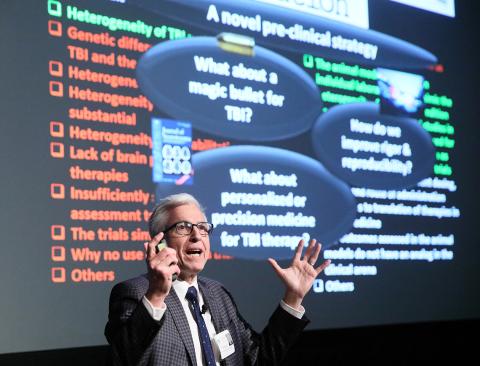 Kochanek gesturing with both hands during his lecture