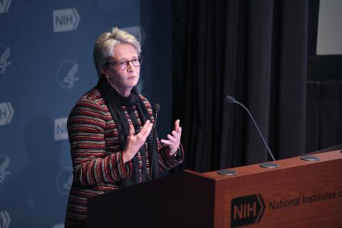 Dr. Butz is speaking at podium.