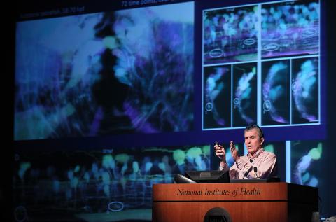 Dr. Betzig gestures during remarks onstage.