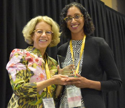 Bianchi holds her award, posing with Dr. Vora