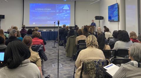 Attendees watch a video presentation.
