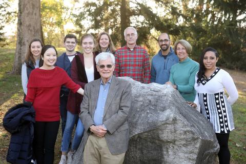 Group shot of 10 people outside smiling for the camera