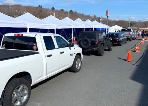 Cars form a line as people wait to get tested at a Covid-19 testing site in Massachusetts.