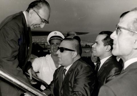 Archival photo shows DeBakey exiting a plane, greeted by Lebanese officials.