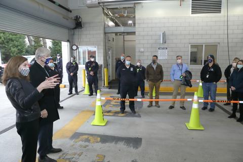 McGowan and Collins stand at the entrance of the car line