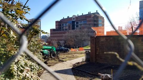 Bldg. 49 viewed through fence hole