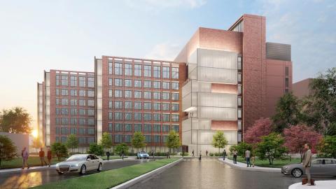 Side view of the Clinical Center with a model showing the proposed, modern brick and glass addition 