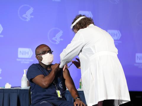 Mr. Mienza is first at NIH to be vaccinated.