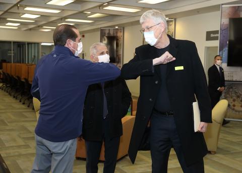 Collins and Azar share elbow bump as Fauci looks on.