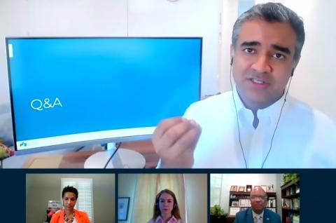 Manchanda talks virtually, curling his fingers as he talks, with three NIH'ers shown listening in.