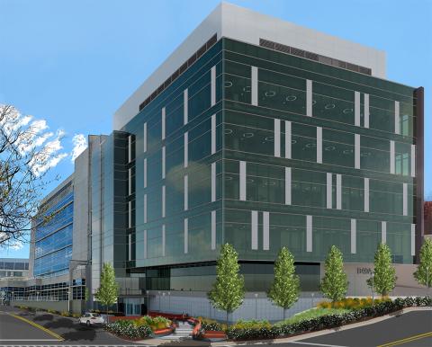 A 5-story modern glass building will attach to the original Vaccine Research Center, shown behind it.