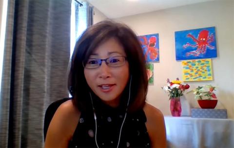 NICHD's Sonia Lee speaks on videocast from her home, with colorful artwork behind her.