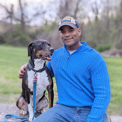 A portrait of Maker and his dog