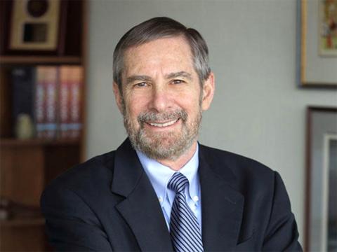 A smiling Lowy in the office