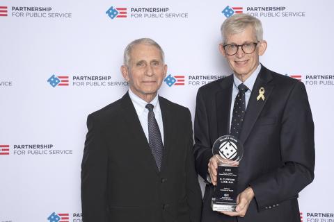 Lane holds his trophy alongside Fauci