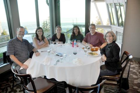 Majocha sits a table with her NCI colleagues and NIH interpreting team