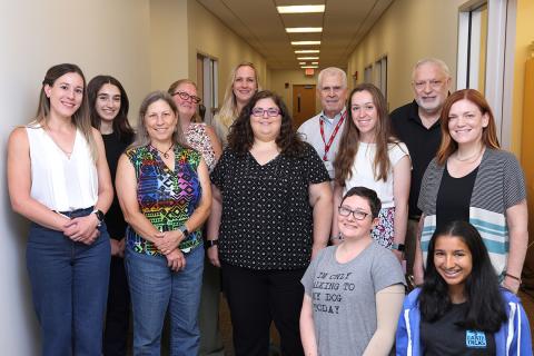 cSw students pose in a group shot with their mentors and the speakers from the visit.