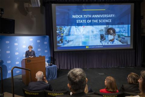 Dr. Laurie McCauley speaks at podium.