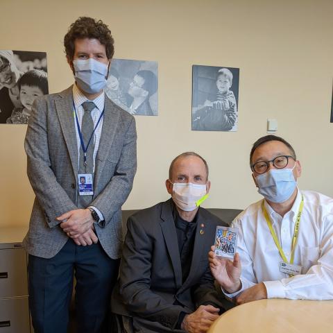 Bulea, Cooper, and Chan, in face masks, look into camera