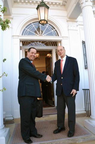Two men shake hands in doorway of Fogarty House