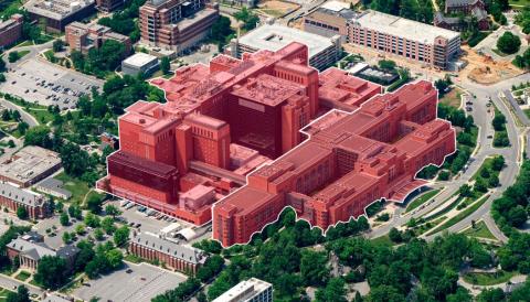 A screenshot shows a close-up aerial view of the Clinical Center complex, surrounded by other buildings