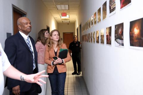 Johnson, Schwetz and McGowan look at photos on the wall of fires and other emergencies.