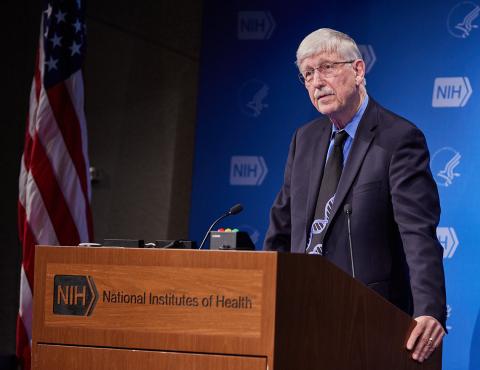 Dr. Collins stands at podium.