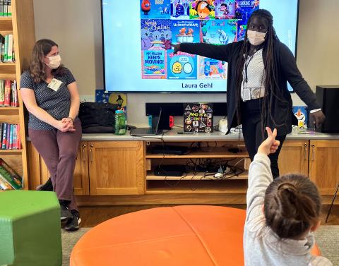 Kumalah of the Children's Inn points to author Laura Gehl as one of the children in attendance points to Kumalah
