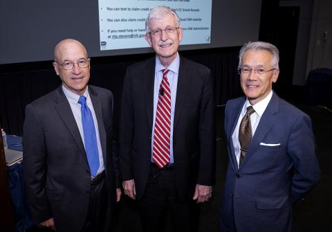 Gilman, Collins and Burklow stand together, smiling, in front of screen in Lipsett Amphitheater