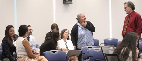 Perez-Stable stands talking informally with seated participants