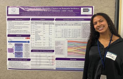 Elise Kinyanjui next to her poster