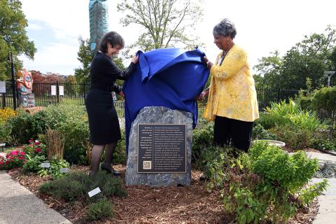 Bertagnolli and Tyson Head pull a covering off the rock